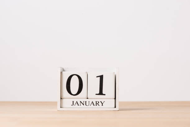 istock January 01 cube calendar on wooden table with empty space for text. 897238022