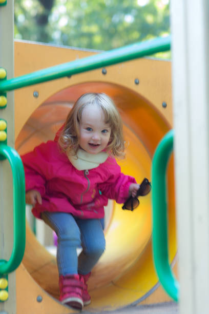 istock girl in motion on a playground 897238110