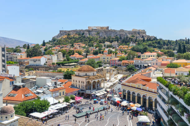 Monastiraki Square in Athens, Greece Monastiraki is a flea market neighborhood in the old town of Athens, Greece, and is one of the principal shopping districts in Athens. The area is named after Monastiraki Square, which in turn is named for the Church of the Pantanassa that is located within the square. Photo contains many locals and tourists visiting the square. athens greece photos stock pictures, royalty-free photos & images