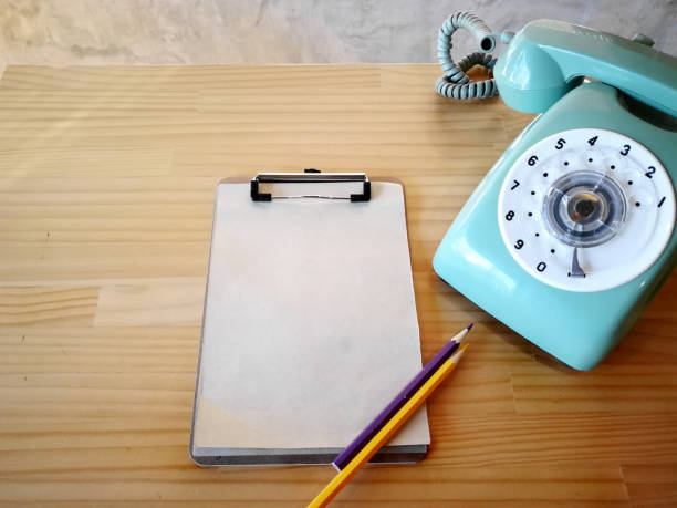 Old telephone , Recycle paper and color pencil on table