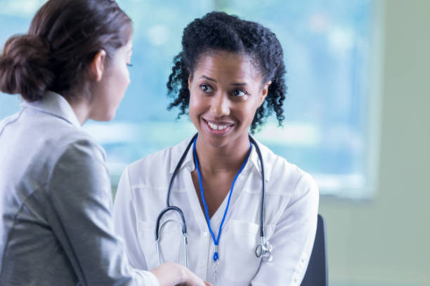 istock Confident doctor talks with new patient 897243404