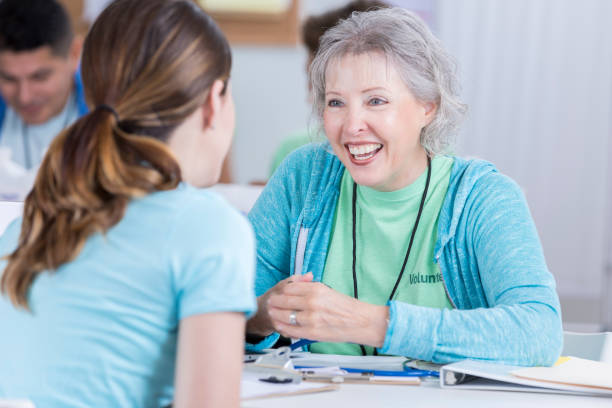 istock Volunteer nurse talks with patient during health fair 897245572