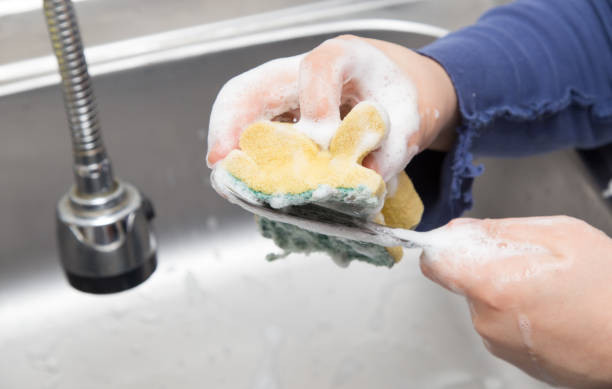 istock boy washing dishes in the kitchen 897250732