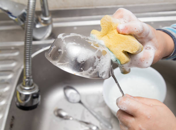 istock boy washing dishes in the kitchen 897253186