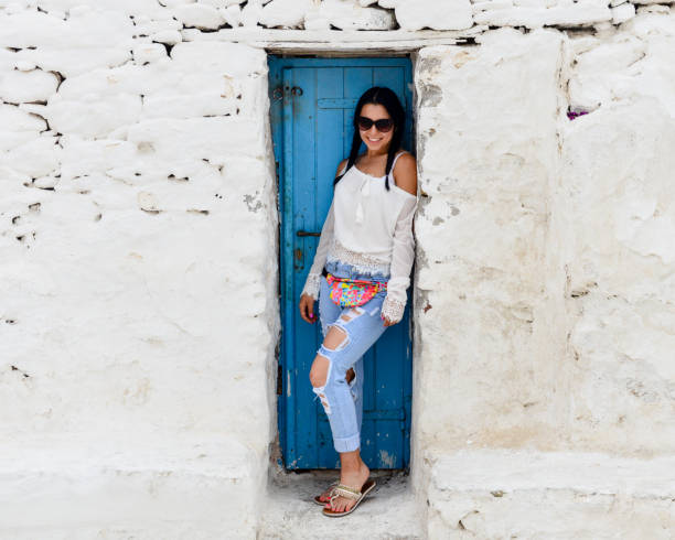 istock Beautiful young woman with typical Greek architecture - Mykonos 897258072