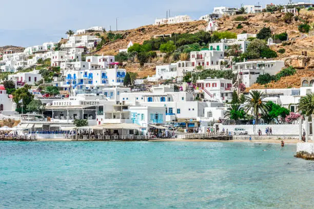 Beachgoers enjoy a beautiful beach on Mykonos island.