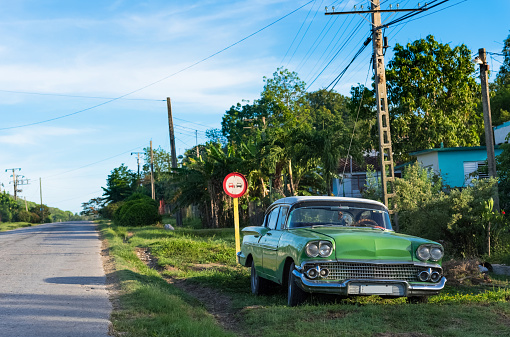 Green american vintage car car parked on the side street to Santa Clara Cuba - Serie Cuba Reportage