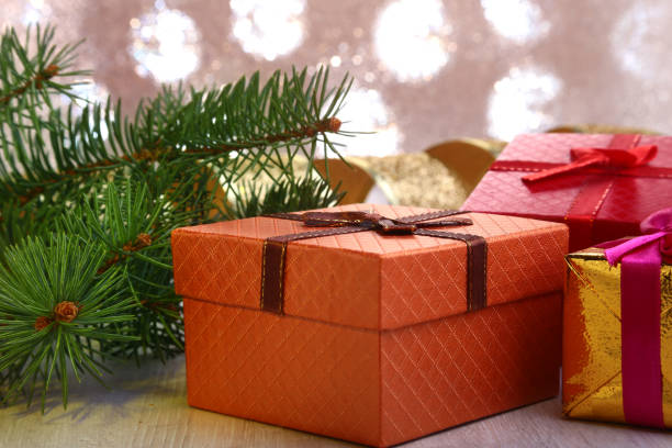 istock Christmas decoration with gift boxes and christmas tree on a blurry, sparkling and fabulous background. 897277452