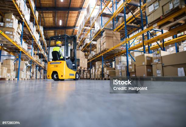 Warehouse Man Worker With Forklift Stock Photo - Download Image Now - Warehouse, Forklift, Distribution Warehouse