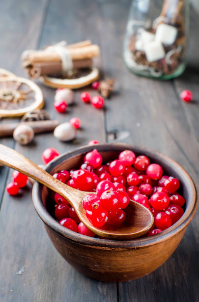 istock juicy cranberries in a plate and spice on wood table 897283666