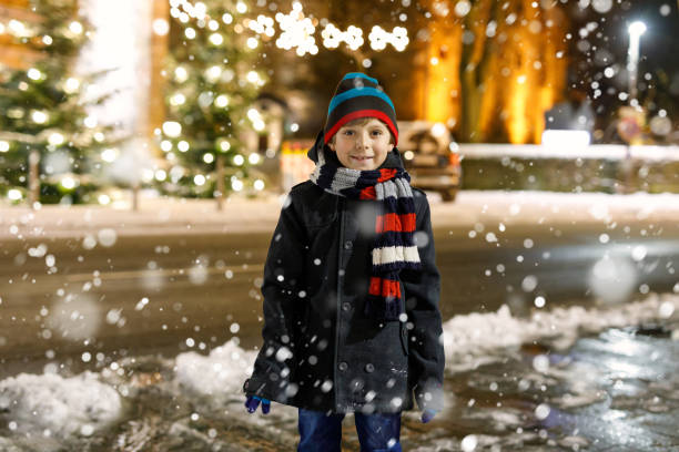 istock Happy kid boy having fun with snow in winter 897295702