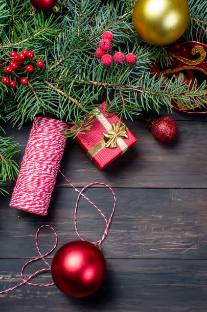istock Gift box tied with a red ribbon , fir branches, 897298172