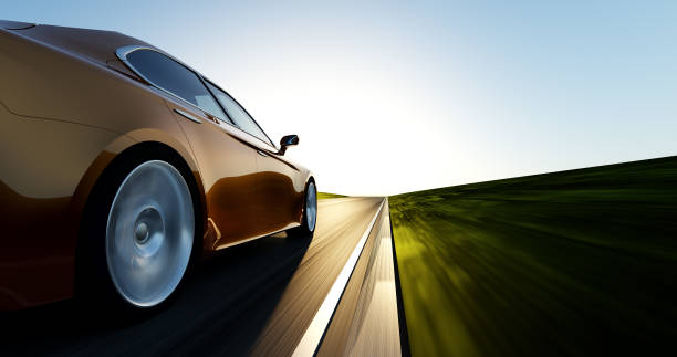 istock car driving on a sunset road 897305924