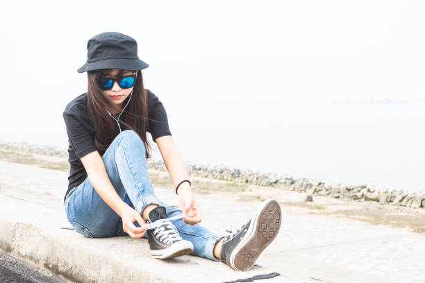 An overhead shot of black sneakers on an asphalt ground - copy space and background