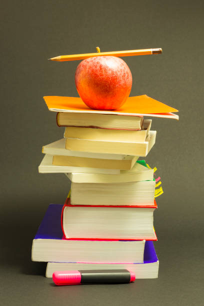 istock Messy pile of school books with red apple 897312006