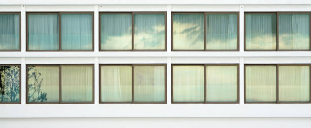 istock Elevation of the generic large sliding window with brass frame on the white building 897319042