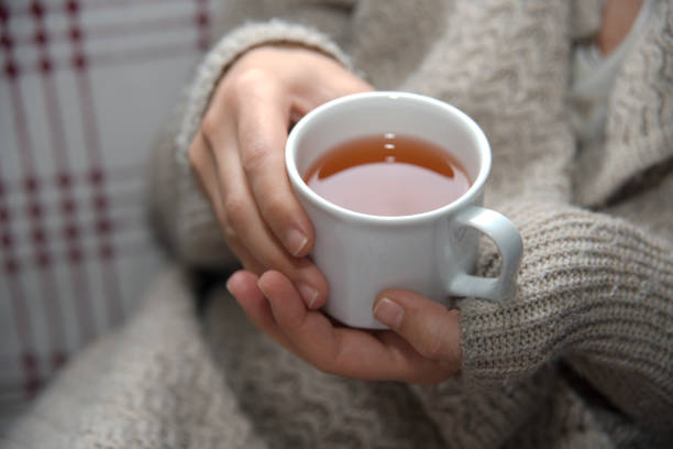 istock Hand Holding A Cup Of Herbal Tea 897319412