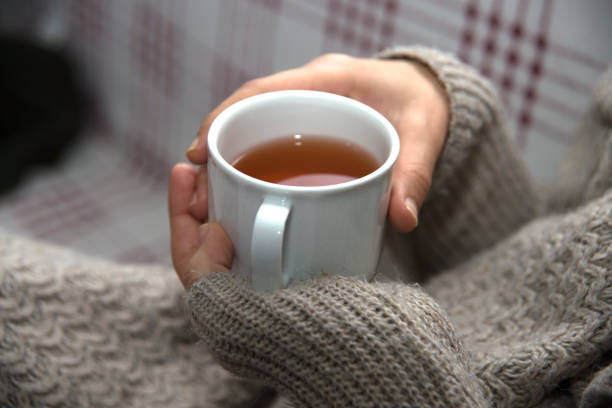istock Hand Holding A Cup Of Herbal Tea 897319416