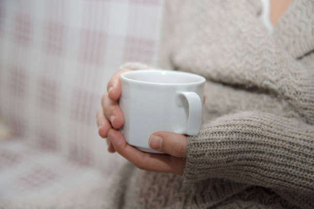 istock Hand Holding A Cup Of Herbal Tea 897319420