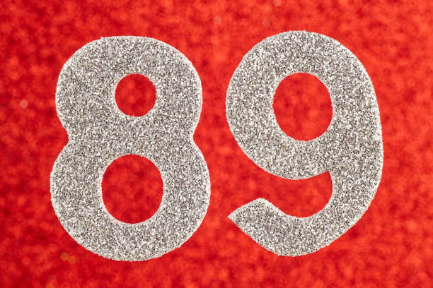 istock Number eighty-nine silver color over a red background. Anniversary 897329378