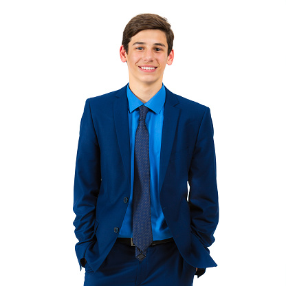 Portrait of a handsome cheerful teenager in a suit on a white background