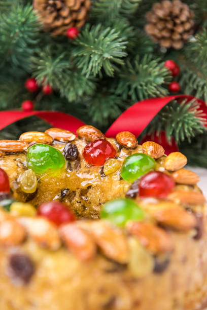 Glazed Christmas fruitcake with pine needles in background