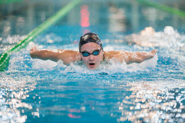 istock Female swimmer - butterfly stroke 897345158