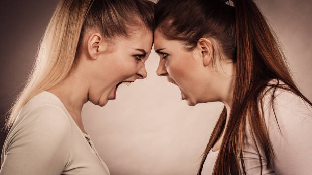istock Two agressive women having argue fight 897347740