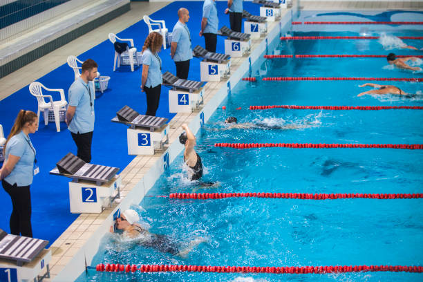 istock Female swimming competition, butterfly stroke, winner celebrating 897347868