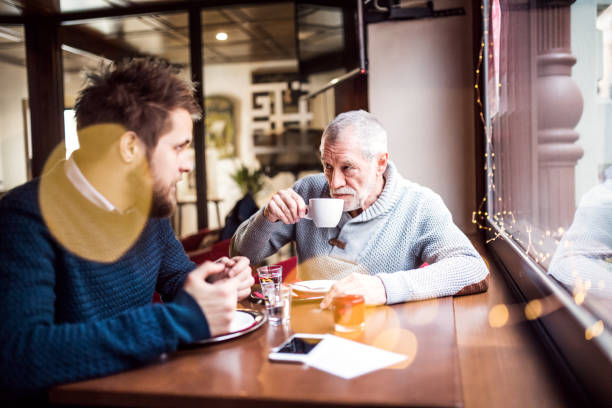 istock Senior father and his young son in a cafe. 897353212