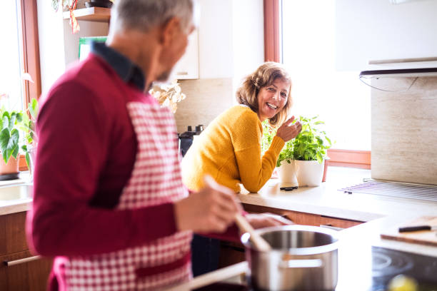 istock Senior couple preparing food in the kitchen. 897360722