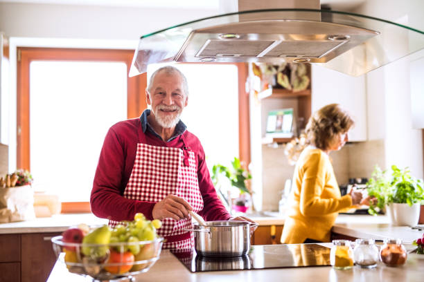 istock Senior couple preparing food in the kitchen. 897360916