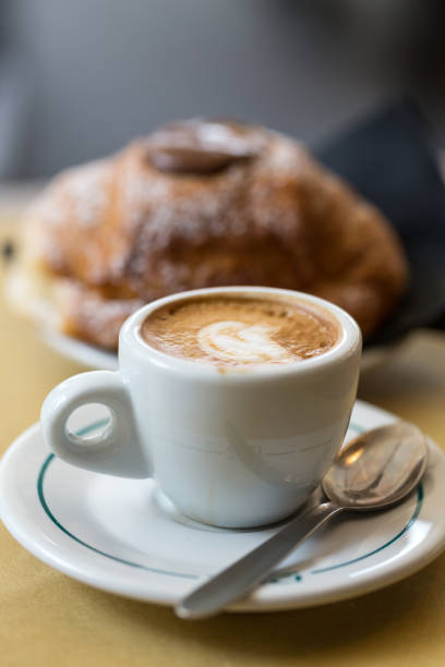 istock Cup of coffee with croissants on the table 897361836