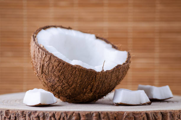 istock a half of coconut and pieces on natural brown background 897370944