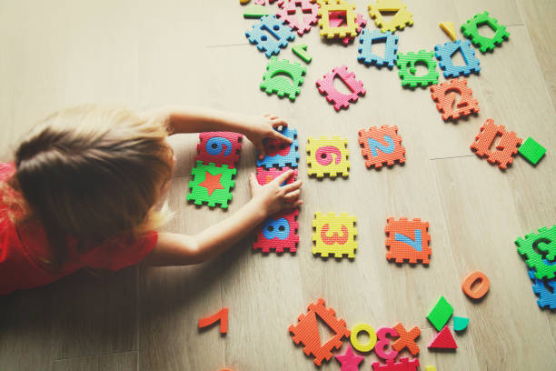 istock little girl learning numbers, education concept 897371408