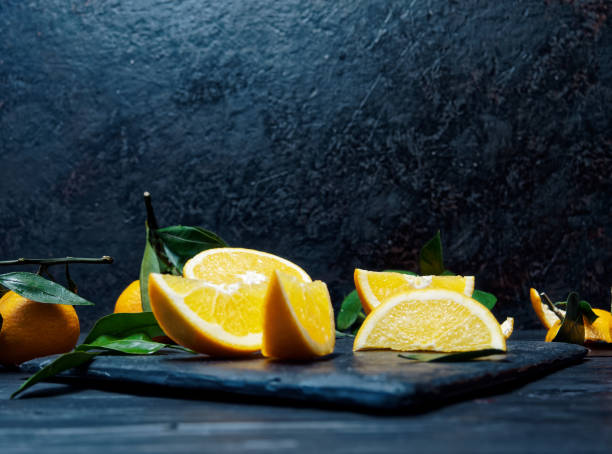 istock Oranges and tangerines over black 897374770