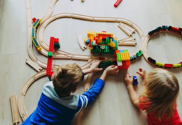 istock kids playing with toy railroad and trains 897375008
