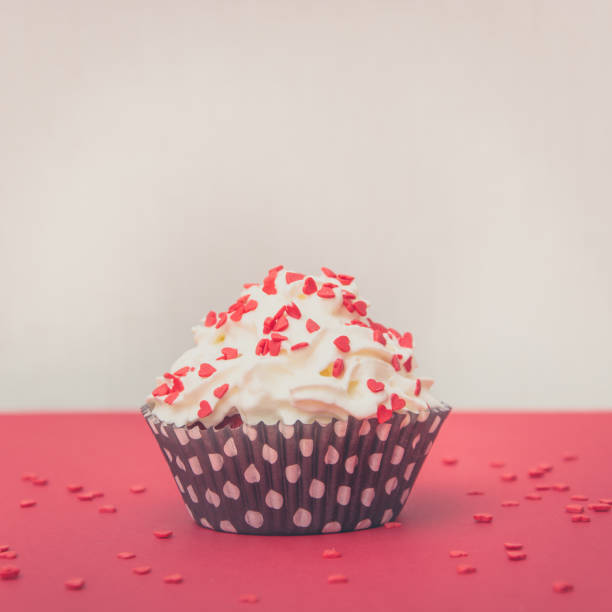 istock Red velvet cupcake on red background, red muffin. Copy space. Square image. Valentine's card. 897375232