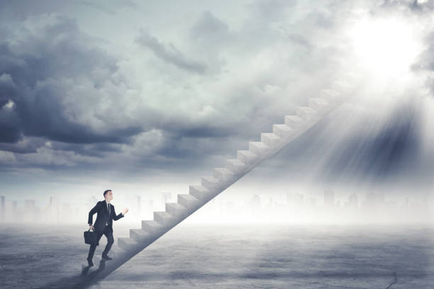 istock Caucasian businessman walking toward sunlight 897375302