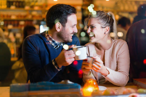istock Young attractive couple on date in bar 897375466