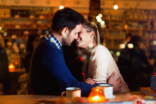 istock Young attractive couple on date in bar 897375782