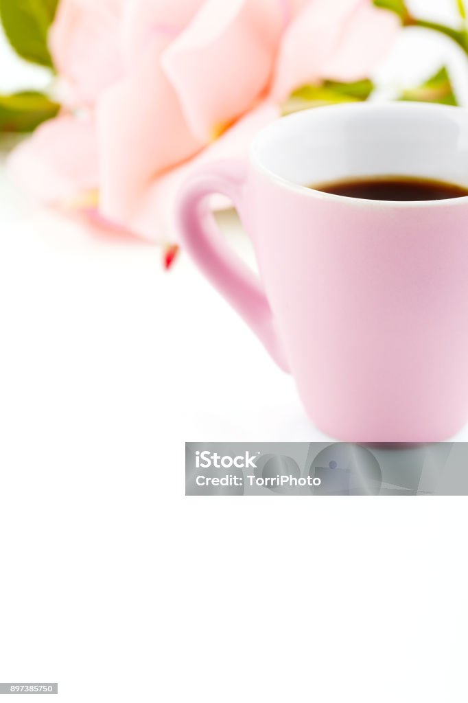 Valentines day background with pink cup of coffee. Copy space White background with pink cup of coffee and rose flower. Romantic Valentines Day backdrop with copy space in pastel color Backgrounds Stock Photo