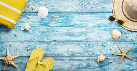 High angle view of summer, vacation, beach accessories on blue wooden background with copy space