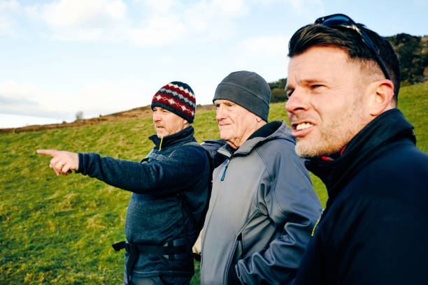 istock Mature people hiking in nature and looking at a view 897410306