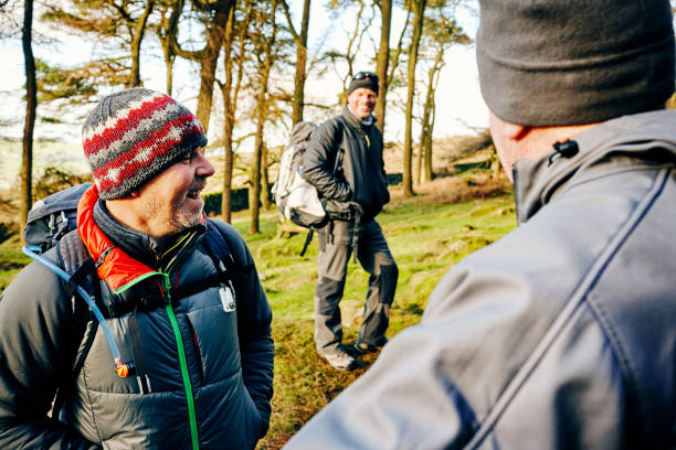 istock Mature hikers standing on mountain trail taking a break 897410360