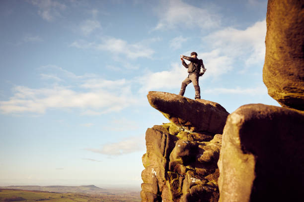 istock Man taking pictures while hiking in nature 897410372
