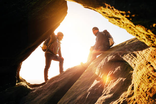 istock Two male hikers relaxing on rocks while hiking. 897410514