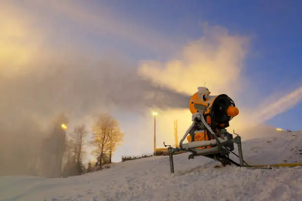 Photo of Snow cannon prepares ski slope early in the morning