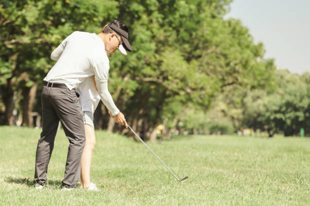 istock Asian couple playing golf 897423654