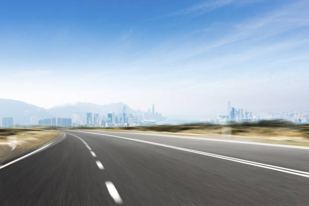 istock empty asphalt road with cityscape of modern city 897429084